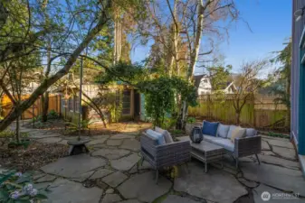 The property has alley access with a one car garage and a rustic garden shed/art studio space. New fence and gate were just built in the back of the property.