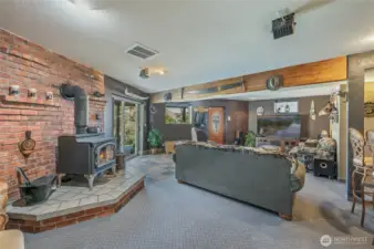 Daylight basement entertainment room, wood burning fireplace