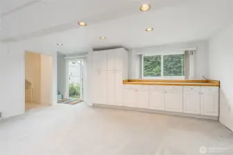 Built-in cabinetry in the rec room. Slider opens to back yard - this could be used as a separate entrance for a JADU or ADU - buyer to verify.