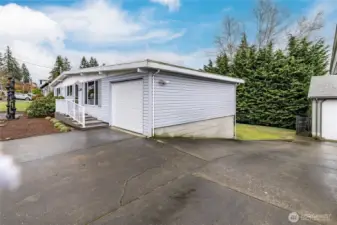 Extended driveway (shared with neighbor) provides convenient vehicle access to the back yard when needed