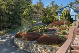 Thoughtfully designed, low-maintenance landscaping with stonework and native plantings enhances privacy while complementing the natural island setting.