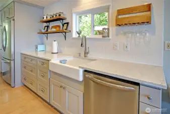 Farm house sink, quartz counters, SS appliances, cabs galore....this kitchen is truly gorgeous!