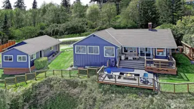 Double lot w/beautiful grounds surround this extensively renovated HIGH bank home on the desirable north end of this wonderful island.  Main home features 2 bedrooms, 2 baths + fun double "bunk room". Stunning HIGH end kitchen + cozy living spaces with stunning views. Guest cottage + ABUNDANT 2+ car garage. Bring your boat, toys....or add on in any way you choose!
