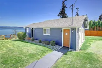 Steps away from the main home is the "guest cottage" and garage. Surrounded with green spaces, spectacular sound + mountain views and lot's of parking too!