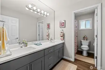 Up[dated full bath dual sink vanity, white 6 panel doors, & separate lavatory.