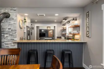 Bar to kitchen beyond provides a more casual dining option.