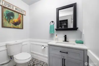 Powder room conveniently located off family room.