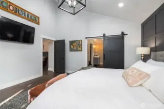 Barn door leads to huge primary bath with walk-in closet.