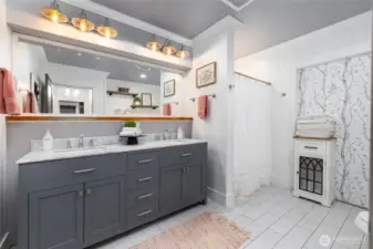 Shared bath with two sinks and shower.