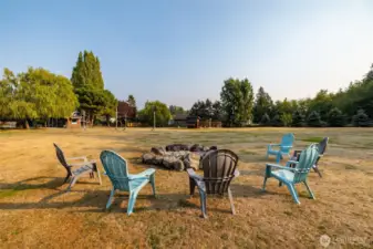 Firepit in the middle of the huge lawn, plenty of room to add a trampoline or pool in summer.