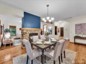 Dining room with gas fireplace. Kitchen is by the photographer in this picture. Office/ Den is just beyond the dining table flowers.