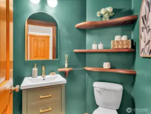 Main floor guest half bath with custom wood shelving.