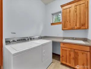 Convenient upstairs utility room with a sink.