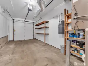 Single car garage. Note the built-in vac system.  Outside there's an EV charger.