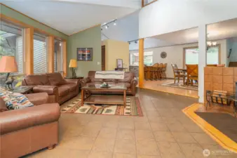 Main living space with wood stove & high ceilings to the upstairs loft.
