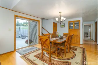 Dining room with sliding door to the back patio. Wide hallway leading to the additional bedrooms/bathrooms. Another coat closet & stairs leading to the loft.