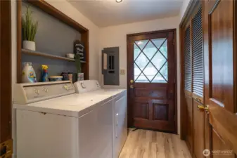 Laundry room with door to front deck. This room houses the electrical panel, water heater & furnace.