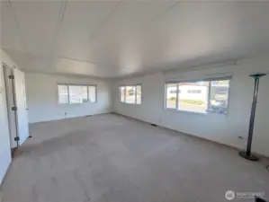 Large living room with windows that open! Blinds stay.