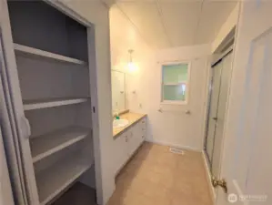 Primary bathroom with a large linen closet. Commode is behind the door.