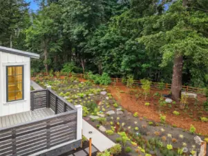 The upper level terrace deck at 2212 NE 125th Street overlooks the lushly landscaped private garden and preserved heritage woodland bordering Thornton Creek.