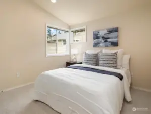 Private bedroom with walk in closet and vaulted ceilings