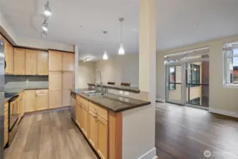 Fresh laminate floors contrast nicely with kitchen cabinets.