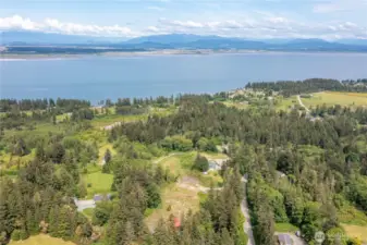 The home is pictured with the red roof at the base of the frame, one can see the magnificent views and area where this uniqe property is located!