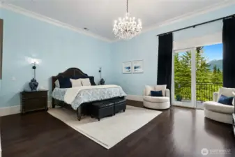 The oversized primary bedroom is a tranquil sanctuary, featuring Brazilian cherry wood floors and double-door access to a private terrace—ideal for sipping morning coffee while taking in the breathtaking, ever-changing views of the gardens and majestic Mount Si.