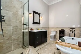Jack-and-jill bathroom with gorgeous tile walk-in shower, and a large claw foot soaking tub.