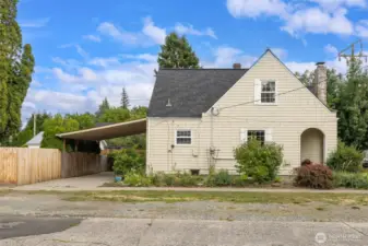 The side view of the house, carport and fenced in back yard. Enjoy some the amazing flowers that will pop up in the spring. Delight in this old fashion flower/herb garden right outside your door.