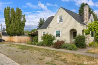 Side yard with plenty of off street parking for your vehicles or your guest vehicles.  Covered porch offers protection as you or your guest enter the front door. Look for the vintage mail slot (a hidden treasure).