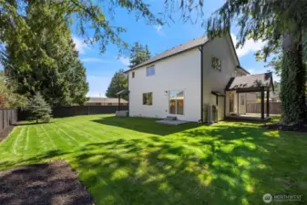 Sunny north yard with the covered Outdoor Living area for Barbeque or beat the heat shaded quiet congregation.