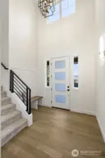 Soaring & bright entry with a gracious custom crafted bench to make it easy for guests to encourage them to help you keep the gorgeous wall to wall  hardwood floors thruout the first floor in like new condition !!