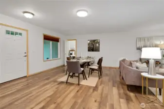 open concept common area staged with dining and living area