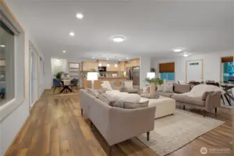 open concept common area staged with dining and living area