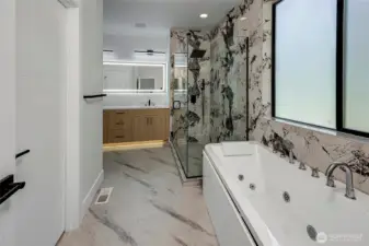 Big and luxurious primary bathroom, full tub and glass shower (virtually staged, photo of similar home in separate community)
