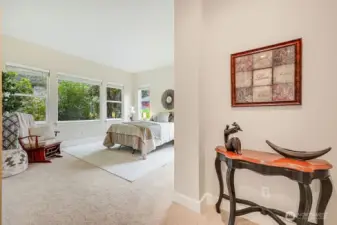 Primary bedroom with windows letting in light and enjoying serenity.