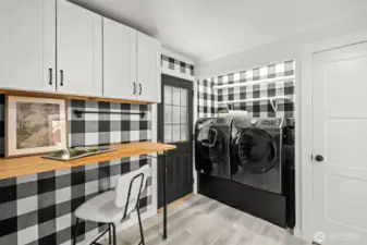 A thoughtfully designed laundry room with abundant storage and plenty of counter space to make laundry day effortless.