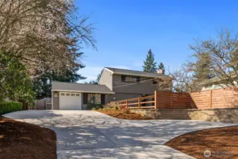 Newly extended driveway, fully fenced, and a flat front yard—perfect for easy parking and curb appeal.