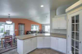 kitchen with pantry, view into dining and living