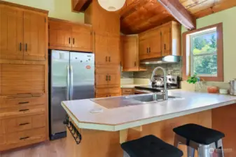 Kitchen with ample storage, window looks out toward deck & back of property.