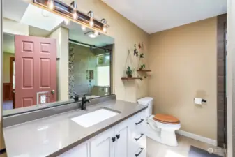 Recently updated primary 3/4 bathroom, with large shower. There's also a good-sized linen closet.