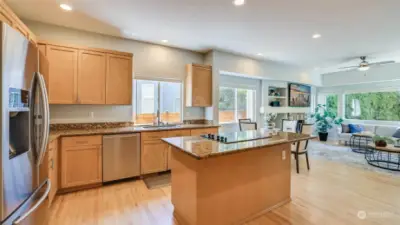 From a different view of the kitchen, you see there is a 3 person eat bar, and eating nook and near to the family room.