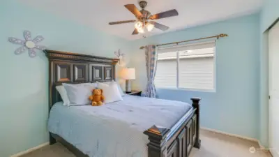 This is one of the 3 additional bedrooms upstairs with a lighted ceiling fan.
