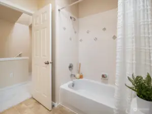 Full bathroom with a tub/shower, and lots of natural lights. Photo shows Unit B (MLS 2276317) with reversed identical floor plan.