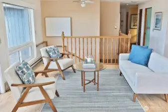 Natural light flood the living, dining, and kitchen areas.