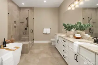 Main level Primary bath with large soaking tub, dual vanities and large shower.