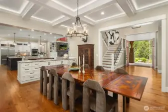 Dining room features coffered ceiling detail and views to the backyard sanctuary.