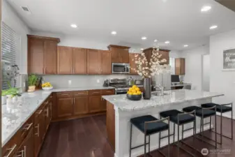 Step into this beautifully designed chef’s kitchen, where style meets functionality. Featuring rich wood cabinetry, sleek stainless steel appliances, and gleaming granite countertops!