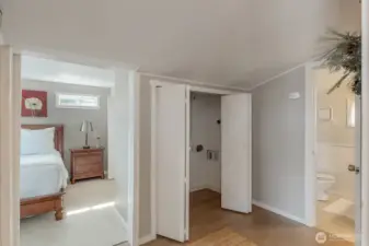 Barn door leads to the Bedroom that is big enough for a king bed and has a large walk in closet. There is so much storage for a small cabin, possibilities are endless!! Closet for washer and dryer with more storage.